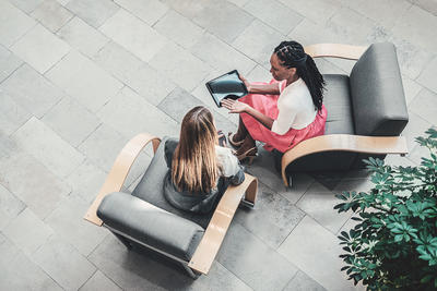 Aerial view of two women working together with a laptop