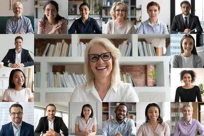 A diverse group of smiling people on a Zoom call screen