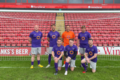 Photo of the team in Outsource UK football kit for charity game