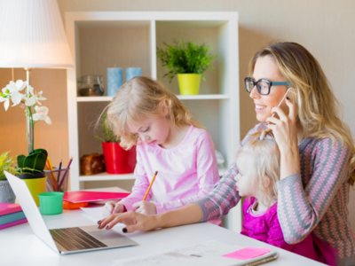 Image of mother with two children while working at home