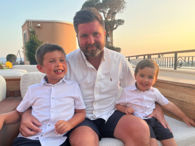 Photo of our Head of Solutions, John Crichton, with his two young boys, on a family holiday with the sun setting behind them.