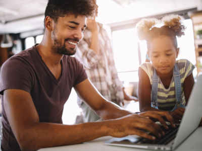 Father and daughter using a laptop