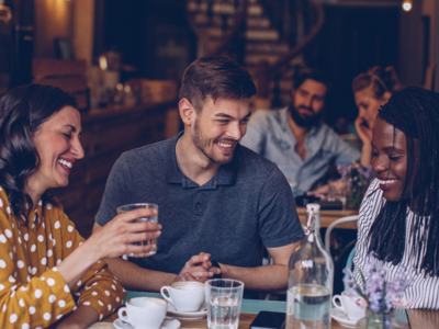 People smiling and talking in a cafe