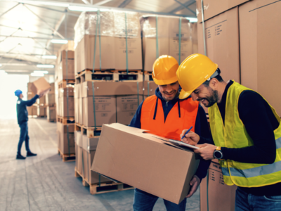 People working in a warehouse and smiling