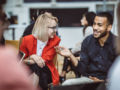 Two people sitting at a table talking
