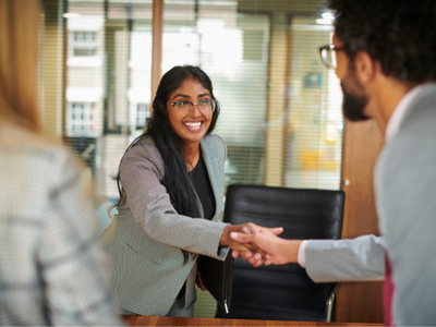 Two people shaking hands in an office